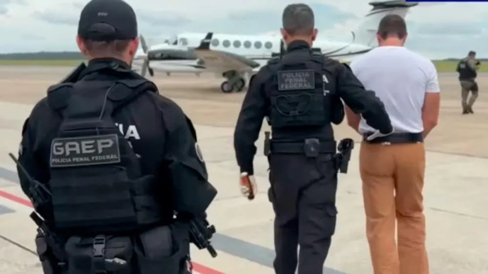 Agentes da Polícia Penal Federal com o banqueiro Daniel Vorcaro. Foto: Captura/YouTube Rádio Bandeirantes